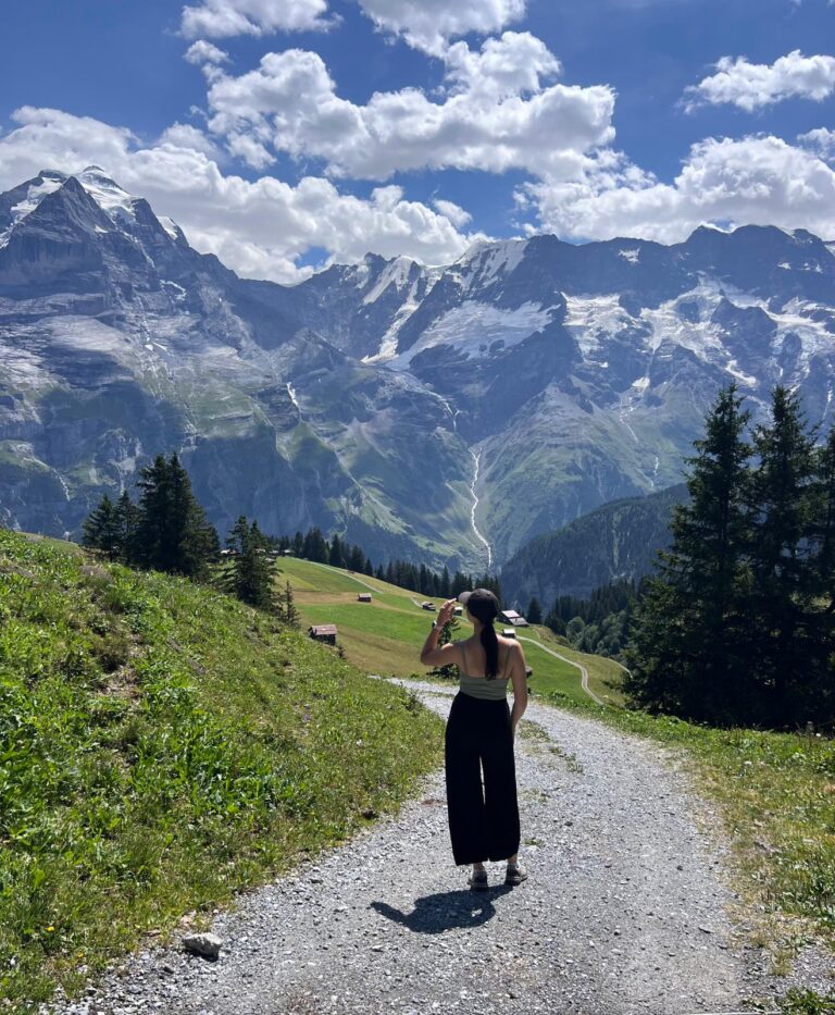 Hiker enjoying the mountain views on the North Face Trail in Mürren